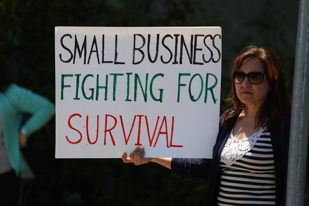 about-us-img Rally goer holds up a u0022Small Business fighting for survivalu0022 sign at ReOpen NC rally in Raleigh, NC.nCredit line appreciated. Thanks.